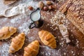 At the bakery, still life with mini Croissants, bread, milk, nuts and flour Royalty Free Stock Photo