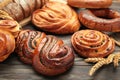 Bakery - various kinds of breadstuff. Bread rolls, bagel, sweet bun on brown background