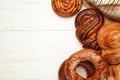 Bakery - various kinds of breadstuff. Bread rolls, bagel, sweet bun on white background. Space for text