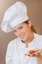 Bakery worker holding macaroons