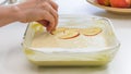 Baking Apple pie. Biscuit batter and sliced apples in a baking glass form. Royalty Free Stock Photo