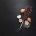 Baking background with flour, eggs, kitchen tools, utensils  on dark table. Top view. Flat lay style. Mock up Royalty Free Stock Photo