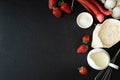 Baking background. Food ingredients for baking: flour, eggs, sugar, milk and berries on dark background. Flat lay. Copy space. Top Royalty Free Stock Photo