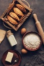 Baking background, ingredients for cooking pies, flour, butter, milk, eggs. Traditional Russians baked patties, pirozhki. View