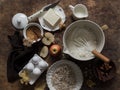 Baking background. Baking ingredients - flour, butter, apples, cinnamon, eggs, cane sugar, nuts - wooden background