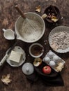 Baking background. Baking ingredients - flour, butter, apples, cinnamon, eggs, cane sugar, nuts - wooden background