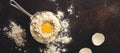 Baking background with ingredients flour, eggs, sugar, butter, cinnamon, anise star and kitchen tools on dark old rustic table. Royalty Free Stock Photo