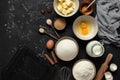 Baking background. Baking ingredients: flour, eggs, sugar, butter, milk and spices on black stone background. Top view Royalty Free Stock Photo