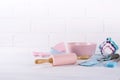 Baking background with kitchen tools: rolling pin, wooden spoons, whisk, sieve, bakeware and shape cookie cutter on white