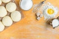Baking background top view. Making sweet bun or bread dough. Cooking ingredients for pastry on wooden board with dough, egg, yeast Royalty Free Stock Photo