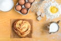 Baking background top view. Making sweet bun or bread dough. Cooking ingredients for pastry on wooden board with dough, egg, yeast Royalty Free Stock Photo