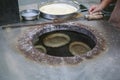 Baking bread cakes in a clay oven. Out of a traditional brick oven Royalty Free Stock Photo