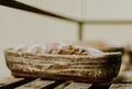 Baking bread. Dough in proofing basket on wooden table with flour, cumin and wheat ears. Top view Royalty Free Stock Photo