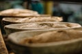 Baking bread. Dough in proofing basket on wooden table with flour, cumin and wheat ears. Top view Royalty Free Stock Photo