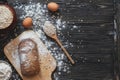 Baking bread at home on a rustic wooden table with space for text layout. View from above.