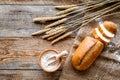 Baking bread with wheat flour and ears on table rystic background top view mockup