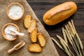 Baking bread with wheat flour and ears on table rystic background top view