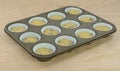 Baking breakfast muffins in muffin pan Royalty Free Stock Photo