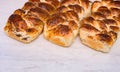 Baking buns with poppy seeds. Three freshly baked wicker buns with poppy seeds close up.