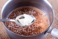 Baking cake. Add butter to cocoa Royalty Free Stock Photo