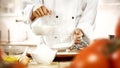 Baking a cake and bread. ChefÃ¢â¬â¢s female hands preparing food in the kitchen. Woman in white chef uniform. Royalty Free Stock Photo