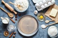 Baking cake in kitchen - dough recipe ingredients eggs, flour, milk, butter, sugar on table. Top view. Royalty Free Stock Photo