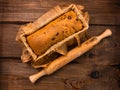 Baking cake with rolling pin on rural rustic wooden background flat lay. Dough recipe ingredients eggs wholegrain flour