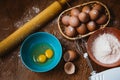 Baking cake in rural kitchen - dough recipe ingredients eggs, flour, sugar on vintage wooden table from above. Royalty Free Stock Photo