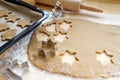 Baking Christmas gingerbread, rolled out dough with cookie cutters, baking tray and rolling pin on a wooden kitchen worktop, copy Royalty Free Stock Photo