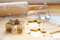 Baking for Christmas, rolled out dough with cookie cutters in star and fir tree shape for traditional gingerbread Royalty Free Stock Photo