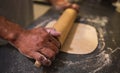 Baking concept. Hands roll dough on black background. Baker cooking pastry. Man rolling out dough on kitchen table Royalty Free Stock Photo