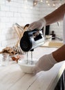 Male hands whisking egg whites and granulated sugar on white wooden table Royalty Free Stock Photo