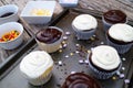 Decorating chocolate and vanilla cupcakes Royalty Free Stock Photo