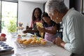 Baking cupcakes, three generations decorating with icing, sharing joyful family moments Royalty Free Stock Photo