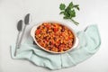 Baking dish with chili con carne on light background