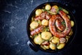 Baking dish with potato and round italian sausage Royalty Free Stock Photo