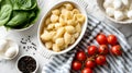 Baking dish of raw conchiglie pasta with cheese, tomatoes and spinach on light background Royalty Free Stock Photo