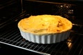 Baking dish with raw homemade apple pie in oven, closeup Royalty Free Stock Photo