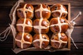 Baking Easter hot cross buns on a wooden board. Traditional Easter baked goods