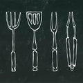 Baking Equipment or Barbeque Tools. Tongs for BBQ, Fork and Spatula. on a Black Chalkboard Background