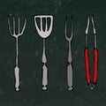 Baking Equipment or Barbeque Tools. Tongs for BBQ, Fork and Spatula. Isolated on a Black Chalkboard Background