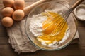 Baking essentials Eggs whisked in a bowl on rustic table Royalty Free Stock Photo