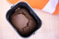 Baking fresh Borodino bread in a bread machine. A black roll lies in a baking dish