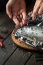 Before baking, fresh fish must be wrapped in foil and aromatic spices and peppers must be added. Close-up of chef hands while Royalty Free Stock Photo