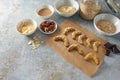 Baking healthy cookies from almond, oat flakes and dates with dark chocolate, ingredients on a rustic gray background, copy space Royalty Free Stock Photo