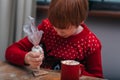 Baking holiday cookies. Child decorates Christmas cookies with icing Royalty Free Stock Photo