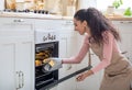 Baking At Home. Young Happy Lady Cooking Croissants In Kitchen