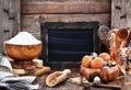 Baking ingredients and blackboard on background, rustic style