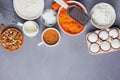 Baking ingredients for a carrot cake flour, butter, brown sugar, grated carrots, walnuts and other Royalty Free Stock Photo