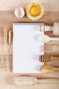 Baking ingredients for cooking and notebook for recipes.